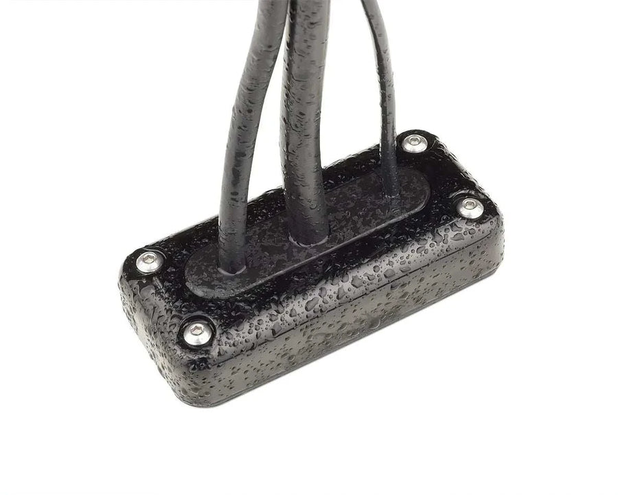 Commercial cable seals waterproofing multiple cables with screw-mounted black plastic housing