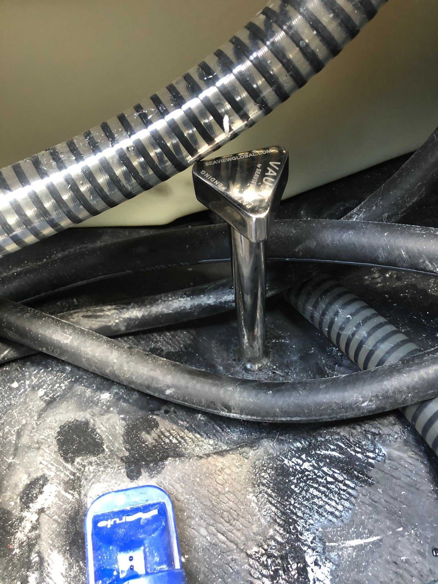 Vault Pro S.S. center boat drain plug installed with hoses.