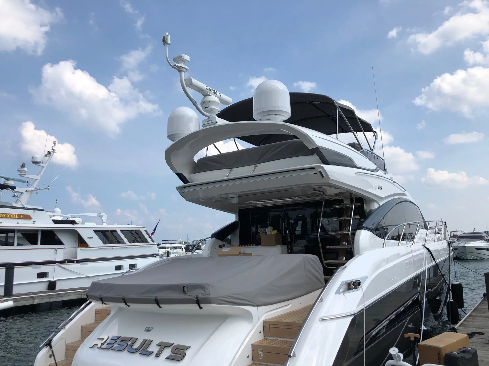 Luxury yacht equipped with Seaview electrically actuated hinge, docked in a marina.