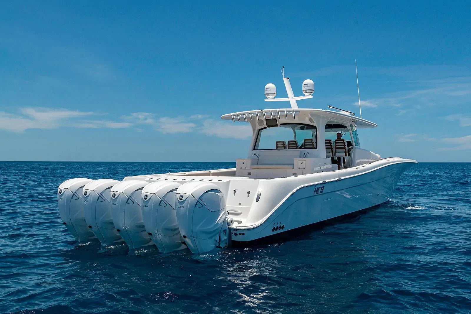Luxury HCB yacht with Seaview Mount on open water with multiple outboard engines.