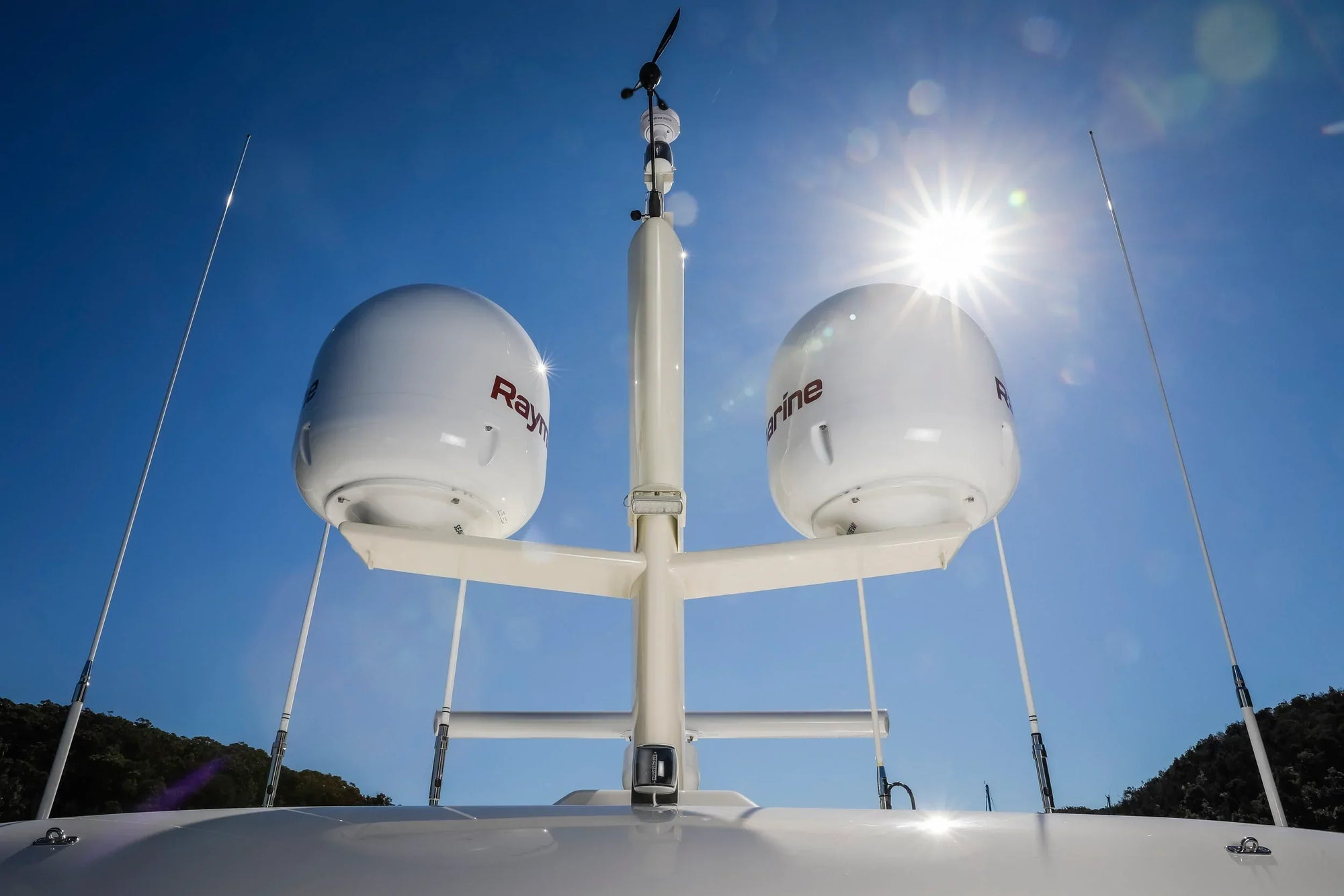 Model #72 custom mast with taper and foil on Fleming 65 yacht against sunny sky.