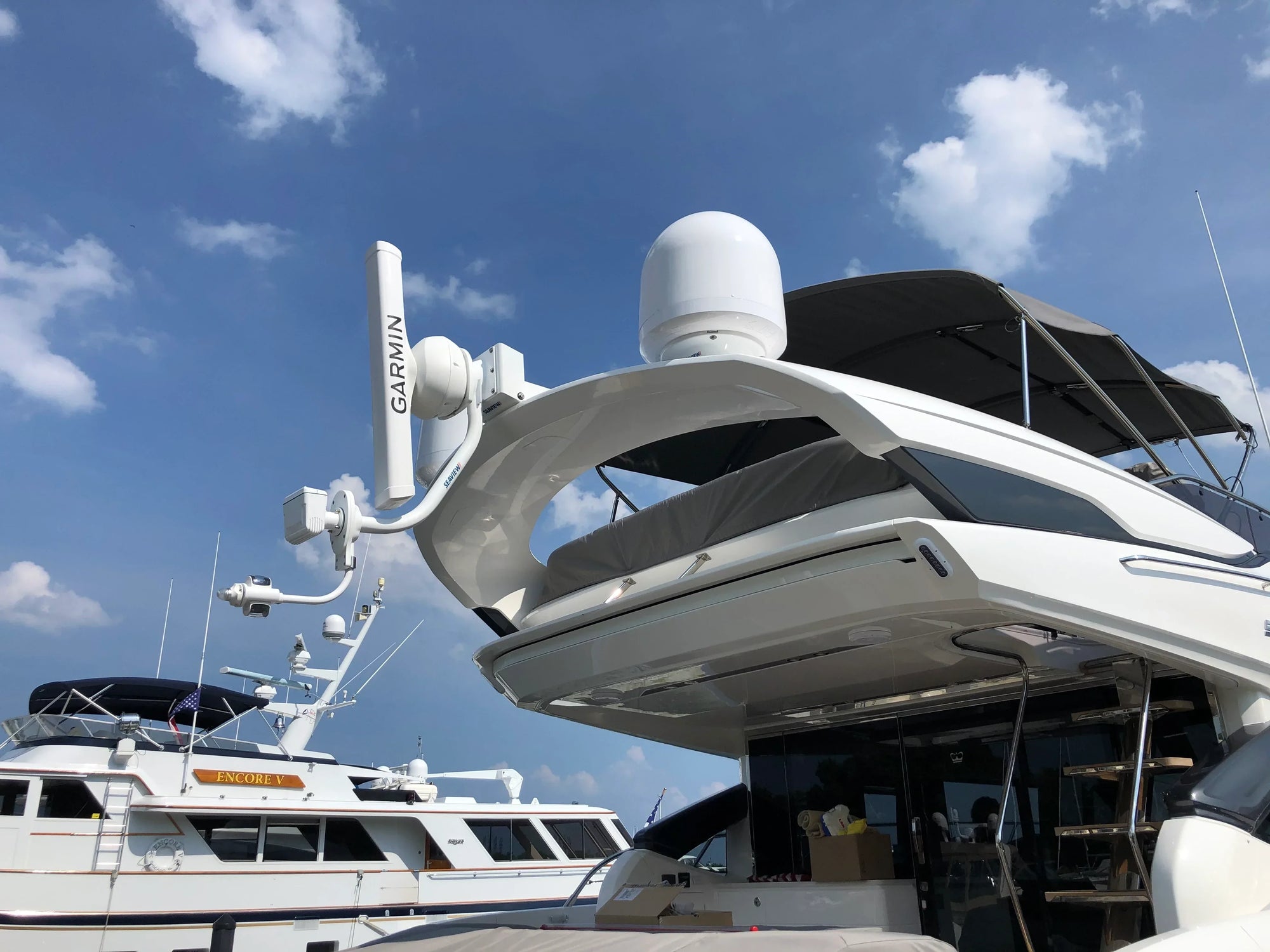 Seaview electrically actuated hinge on yacht, clear sky background.