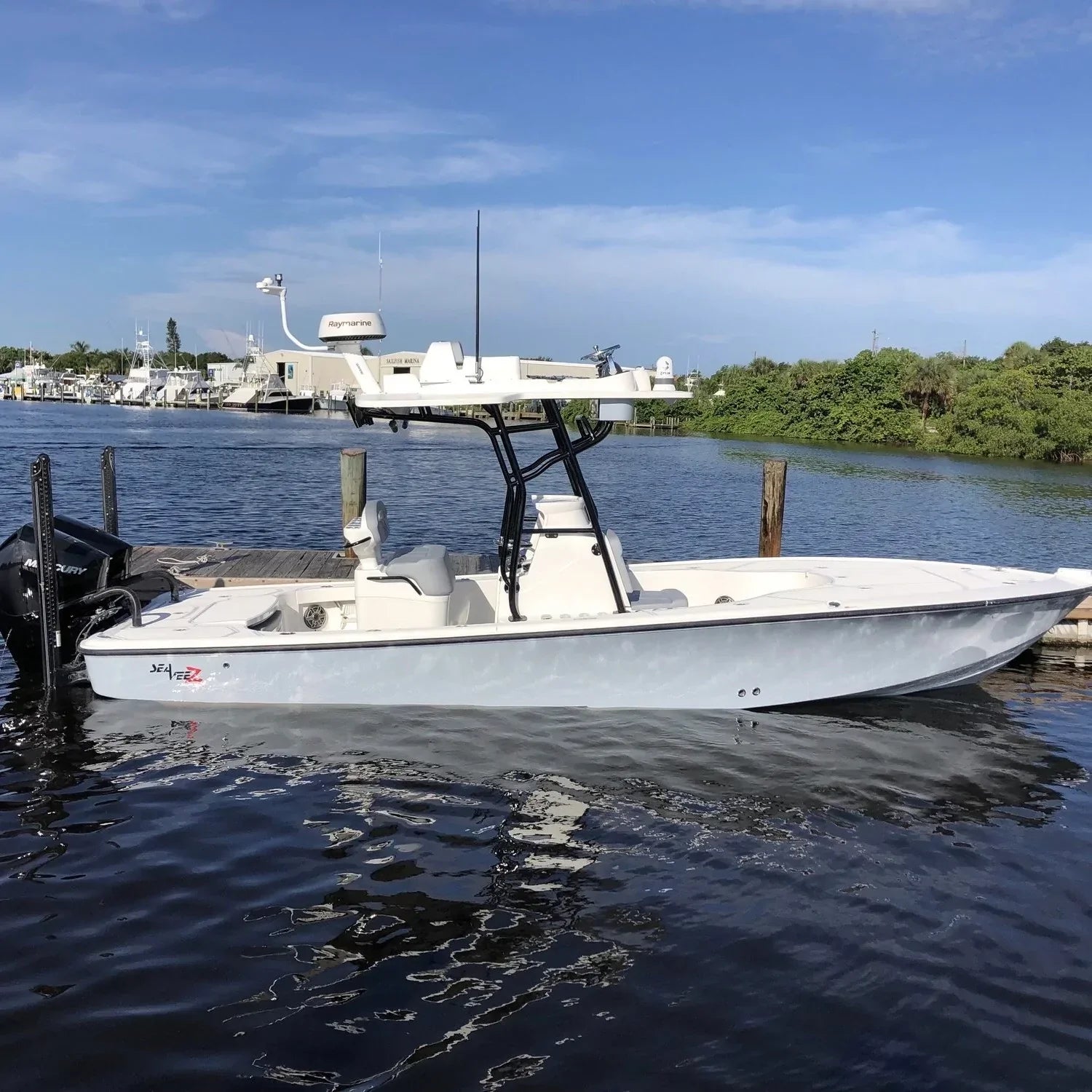 SeaVee boat with Seaview marine electronic mount docked by lush greenery.