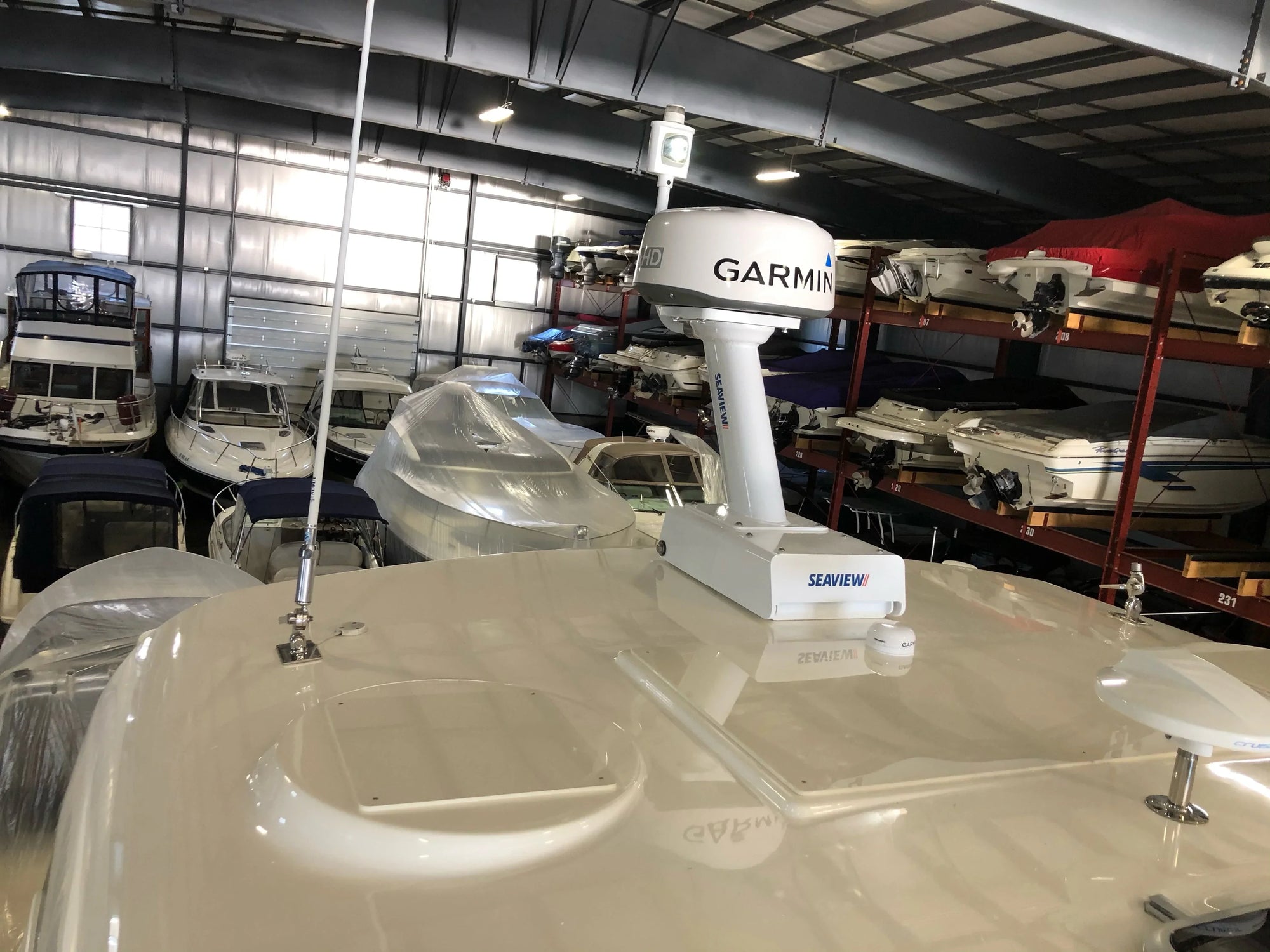 Seaview electrically actuated hinge with Garmin mount in boat storage facility.