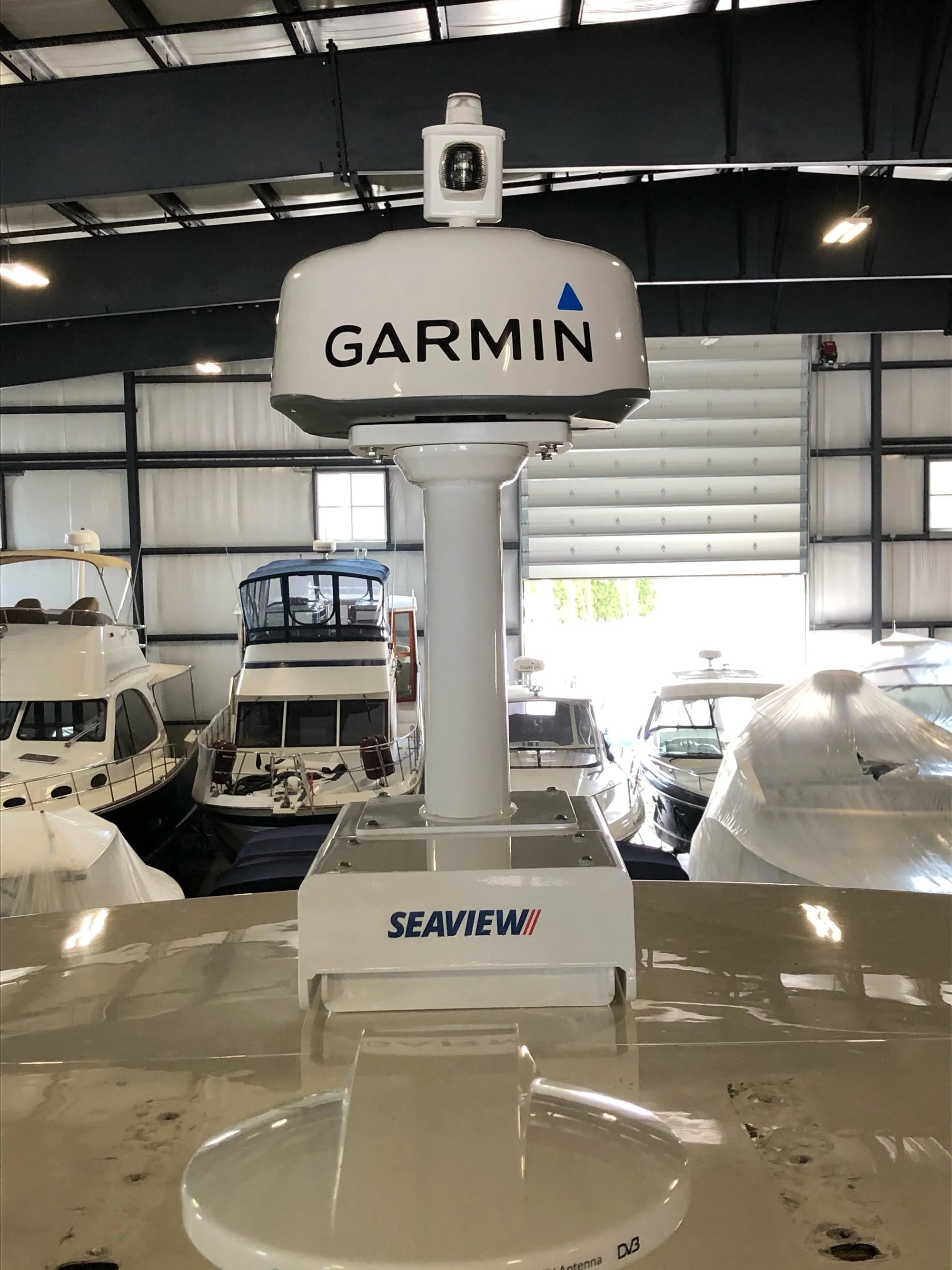 Seaview electrically actuated hinge base installed on a boat, featuring Garmin equipment.