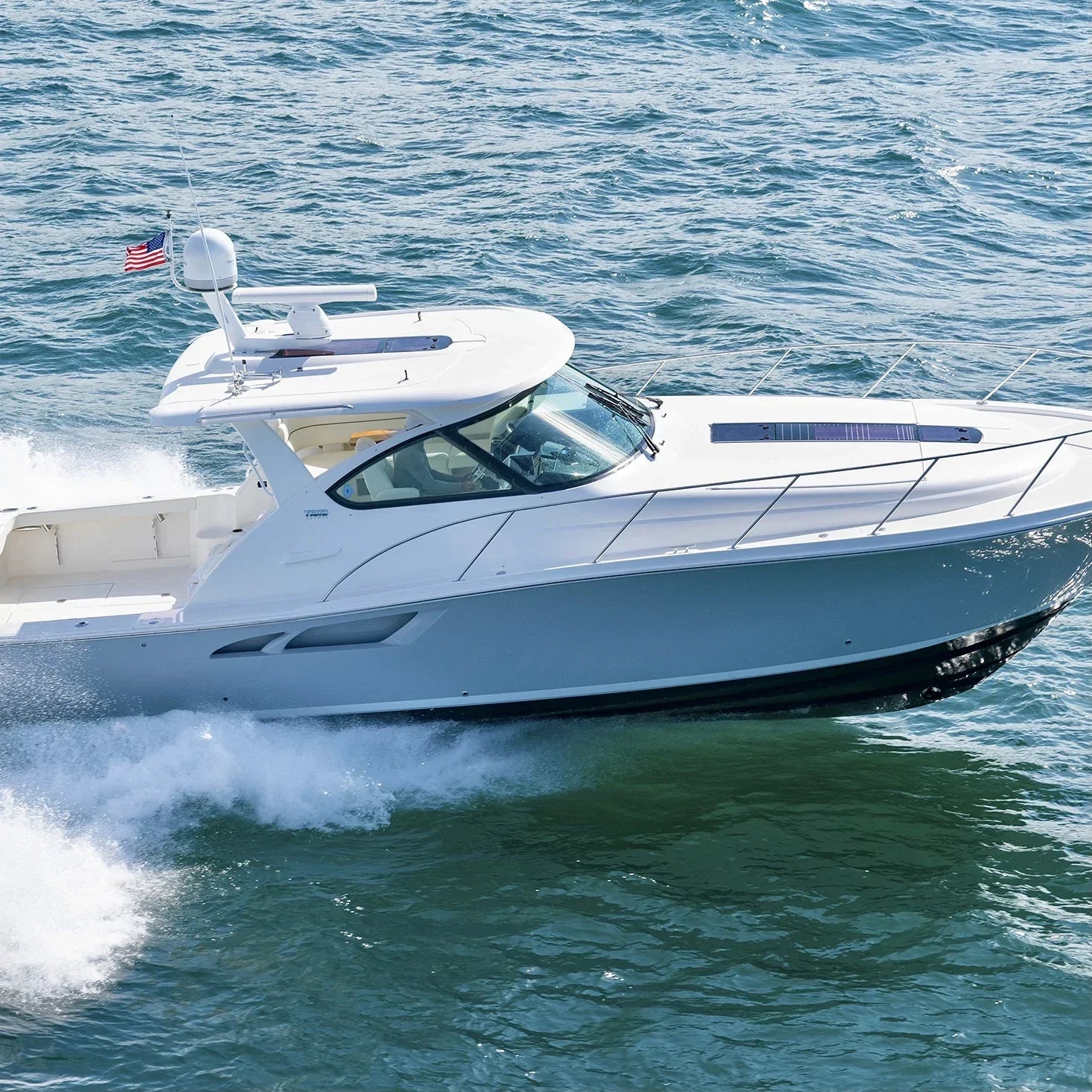 Luxury Tiara Yacht with Seaview radar mount cruising on open water.