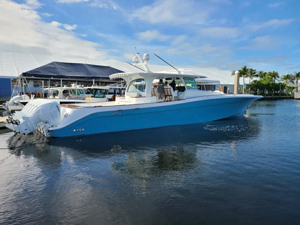 Blue HCB yacht with Seaview custom mast docked in a marina with clear skies.