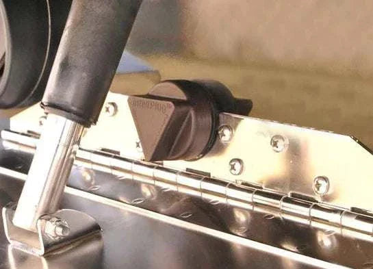 inteliPlug Pro Boat Drain Plug with triangular ergonomic cap on metallic surface.